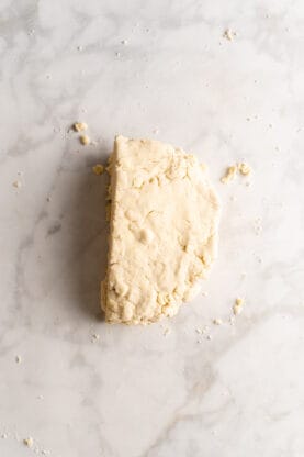 Cut dough stacked on top against marble background