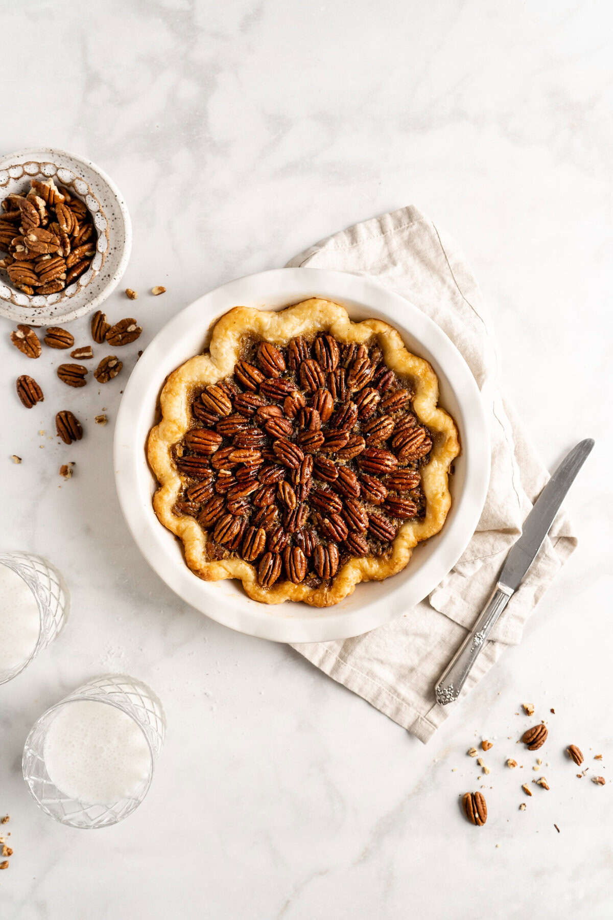 Baked bourbon chocolate pecan pie on white countertop