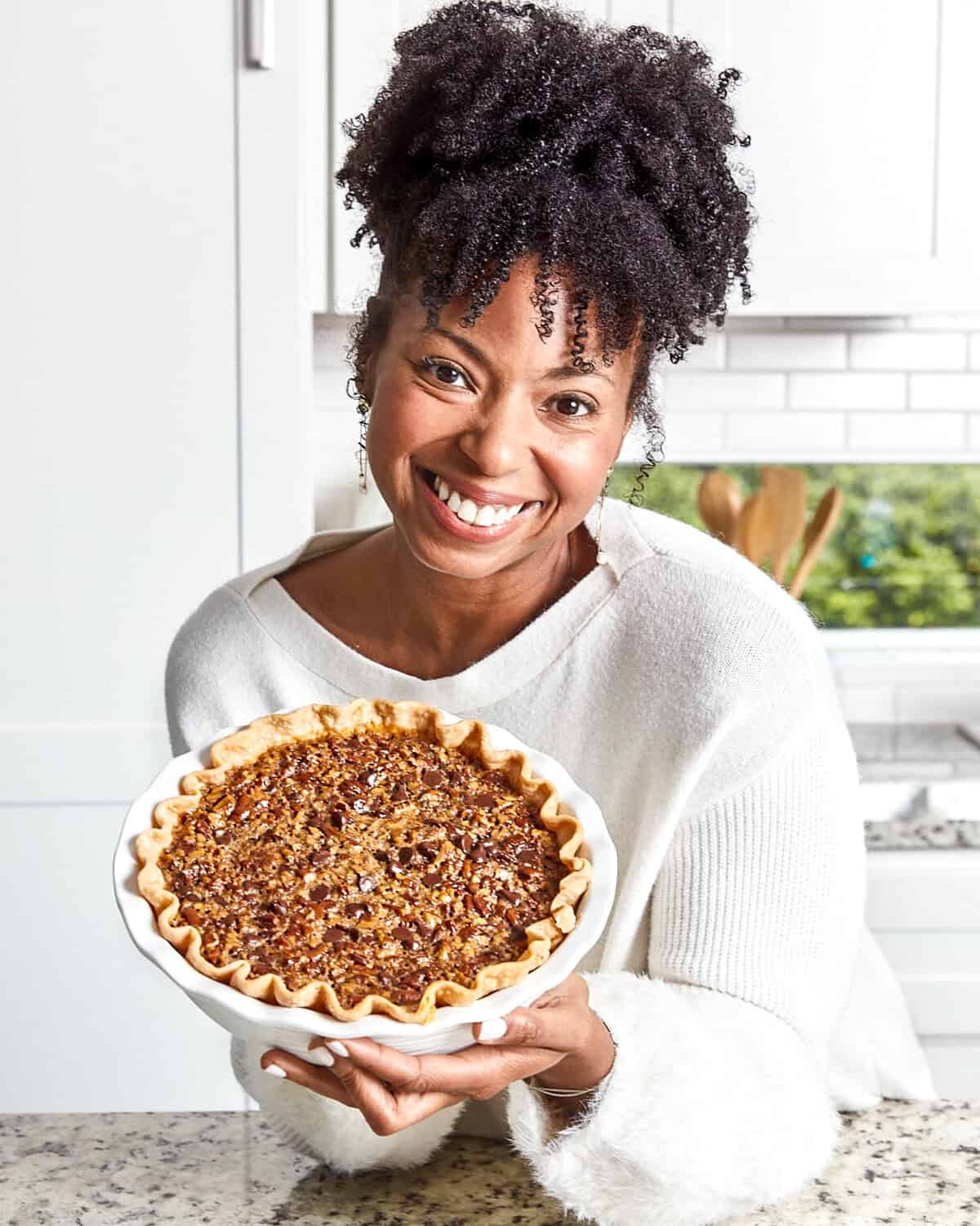 Jocelyn Delk Adams holding her pecan pie with chocolate and bourbon