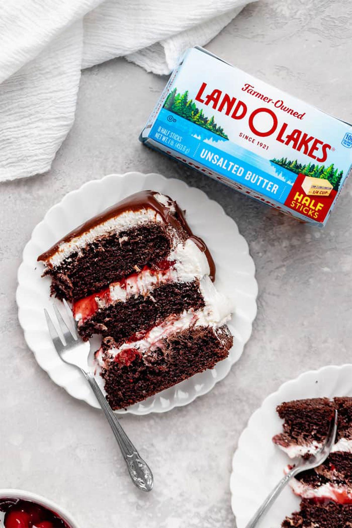 An overhead of black forest cake slices with a box of butter nearby
