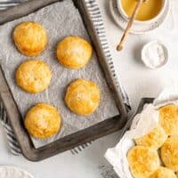 Delicious light biscuits on a baking pan and off to the side