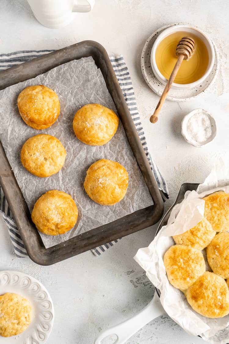 Delicious light biscuits on a baking pan and off to the side