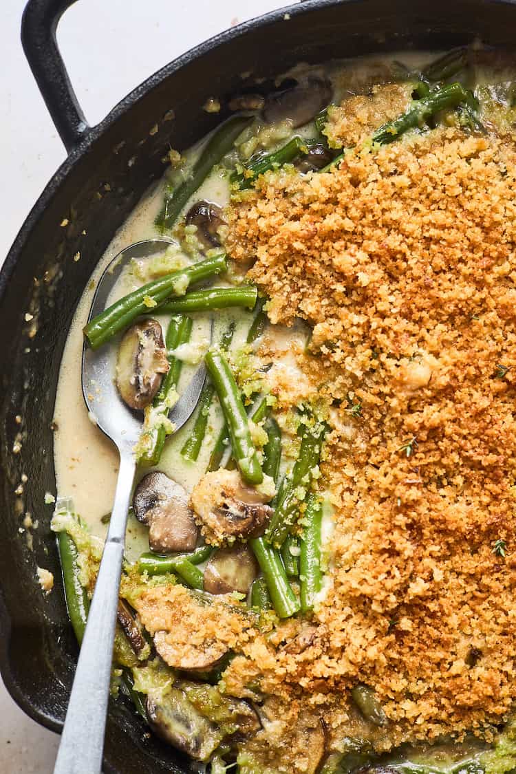 A close up of green beans in a creamy filling with panko crumbs being served