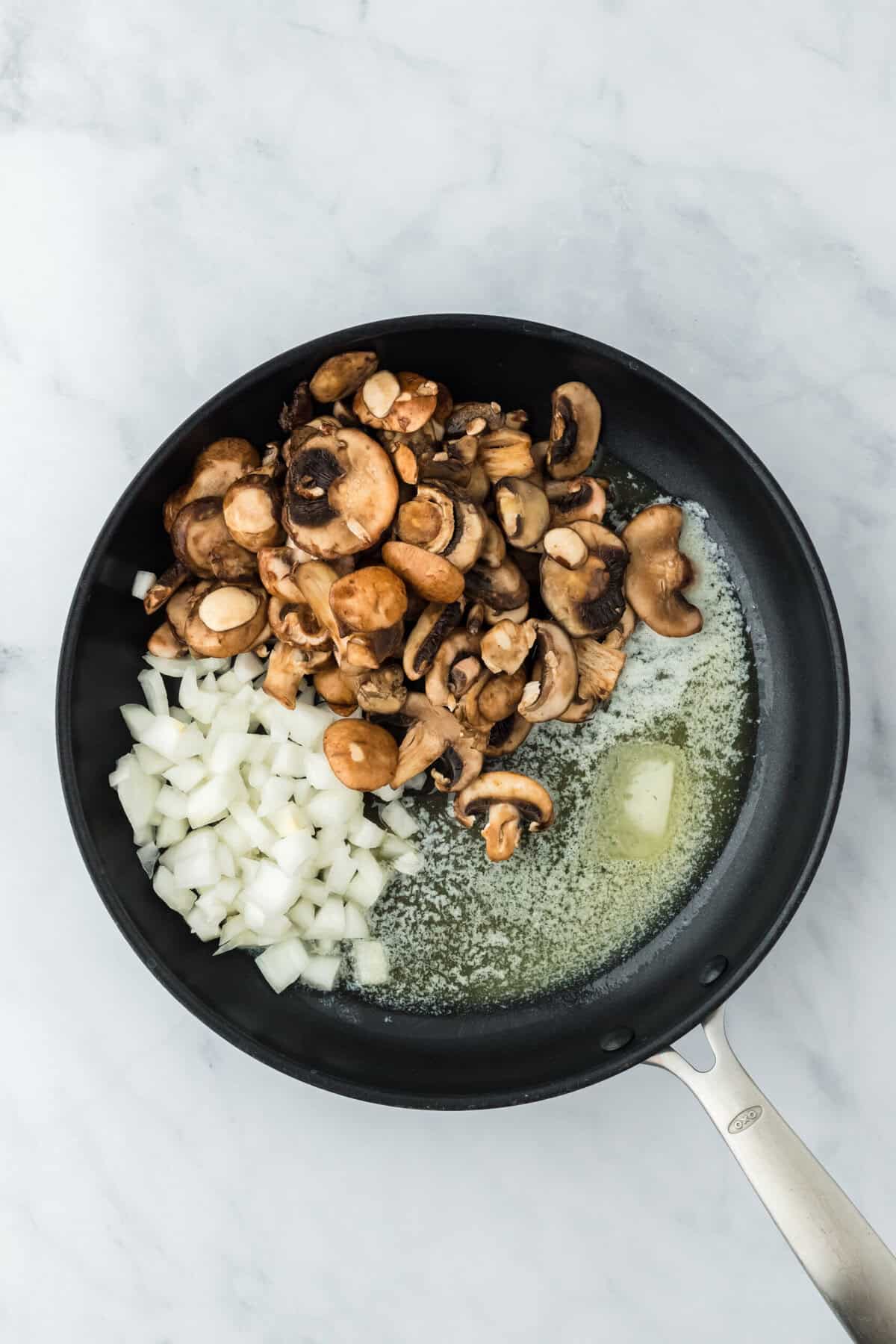 Butter, mushrooms and onions in a large skillet