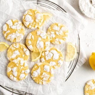 Lemon crinkle cookies on a white wrinkled parchment paper ready to serve