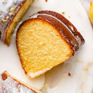 A slice of lemon cake inside of a bundt cake ready to serve