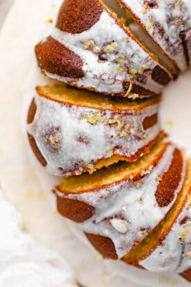 A close up of lemon cake with lemon zest on top ready to serve