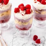 Three raspberry trifles next to one another ready to serve