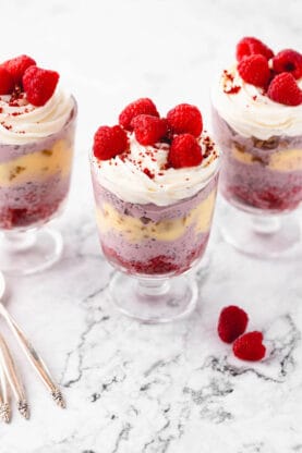 Three raspberry trifles next to one another ready to serve