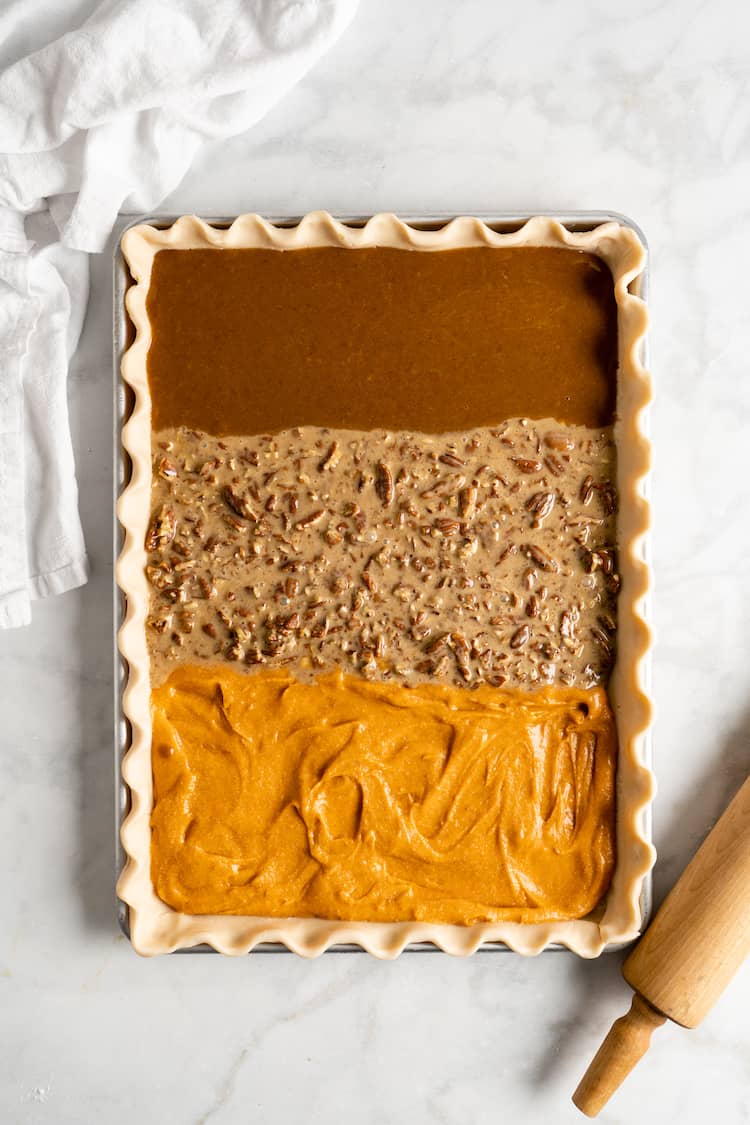 A long pie on a sheet pan before baking in the oven