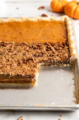 A close up of the texture of a pie with three fillings after being cut into