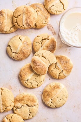 White chocolate chai butter cookies scattered around with dipping white chocolate in a bowl