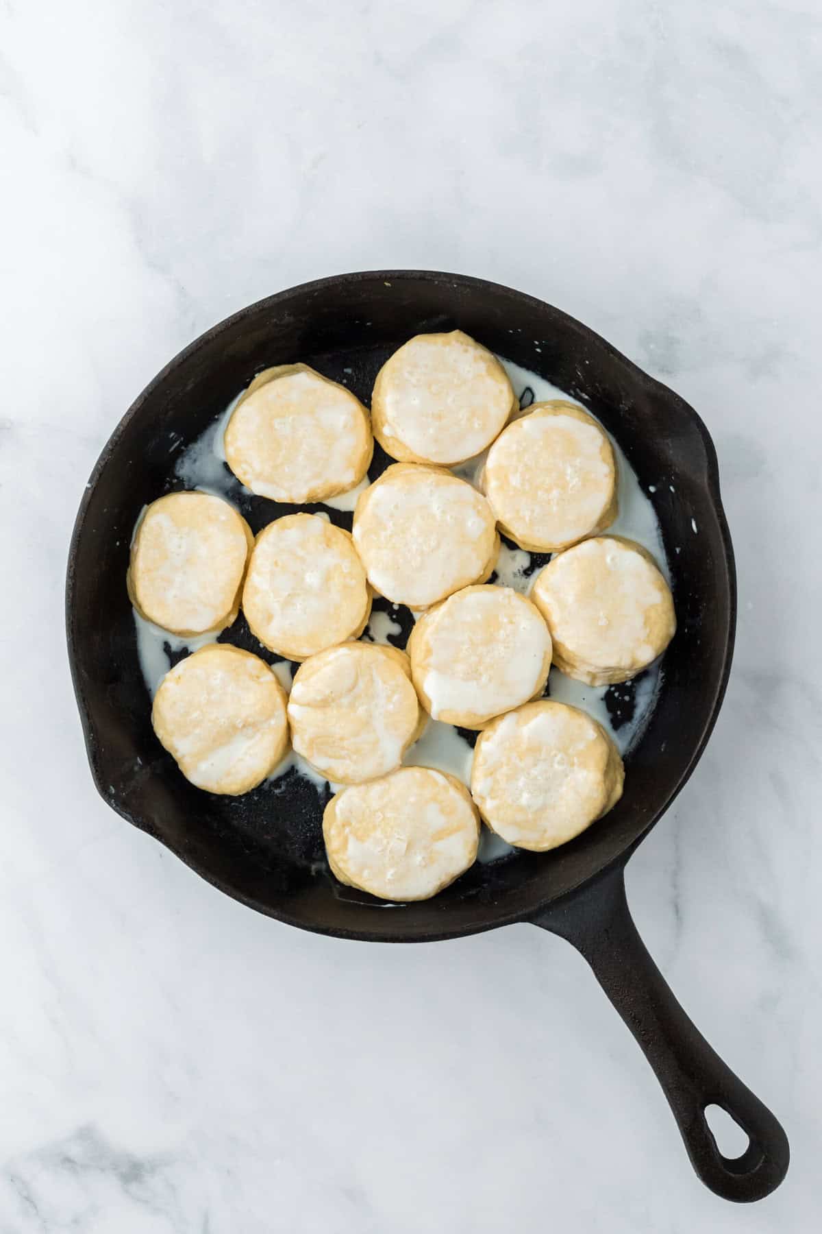 Frozen biscuit rounds in a cast iron skillet