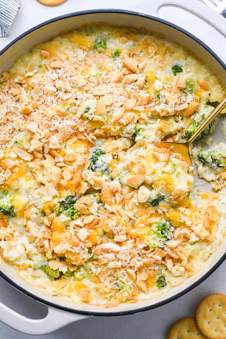 A delicious Broccoli Cheese casserole after it came out of the oven with a spoon digging in
