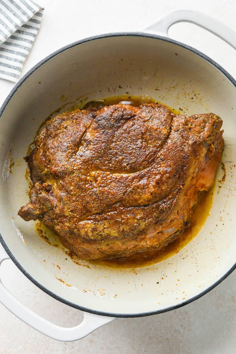 A beef roast searing in a dutch oven