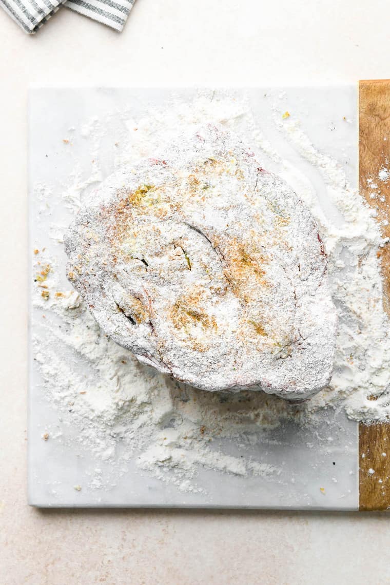 A floured beef roast before frying