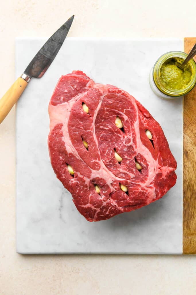 A beef roast that has pockets filled with garlic cloves