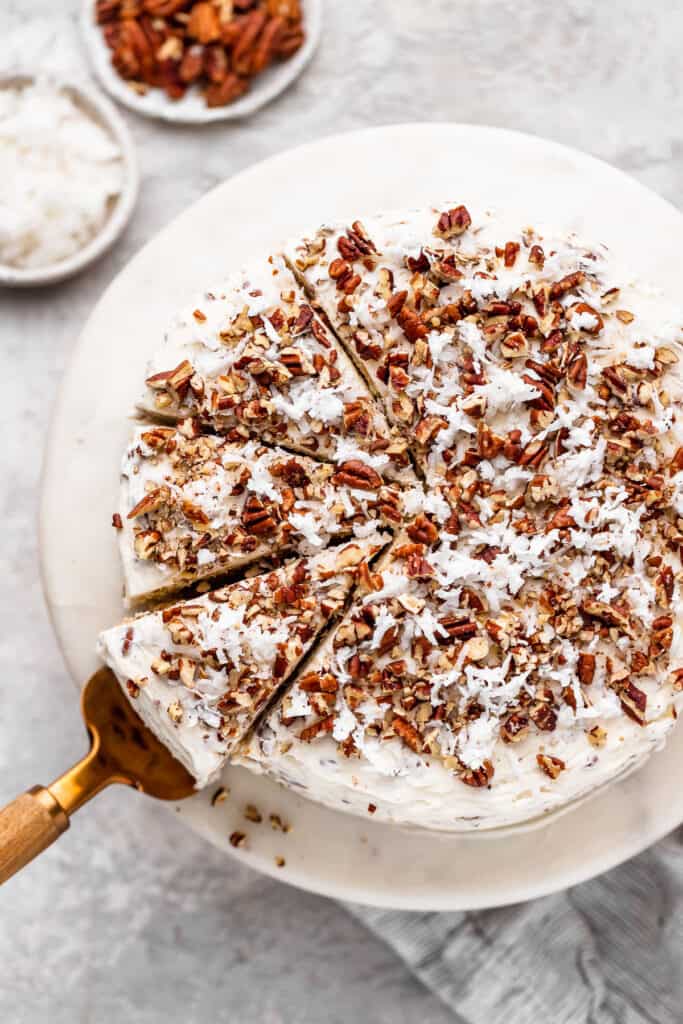 An overhead of a coconut and pecan cream cheese frosted cake