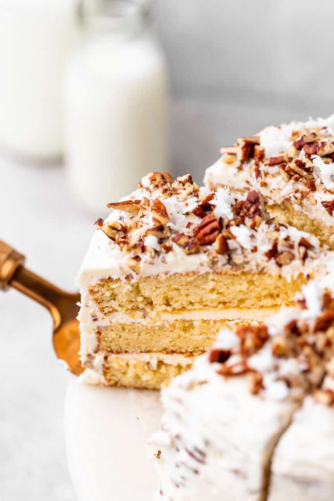 A slice of yellow Italian cake coming out of a layered cake