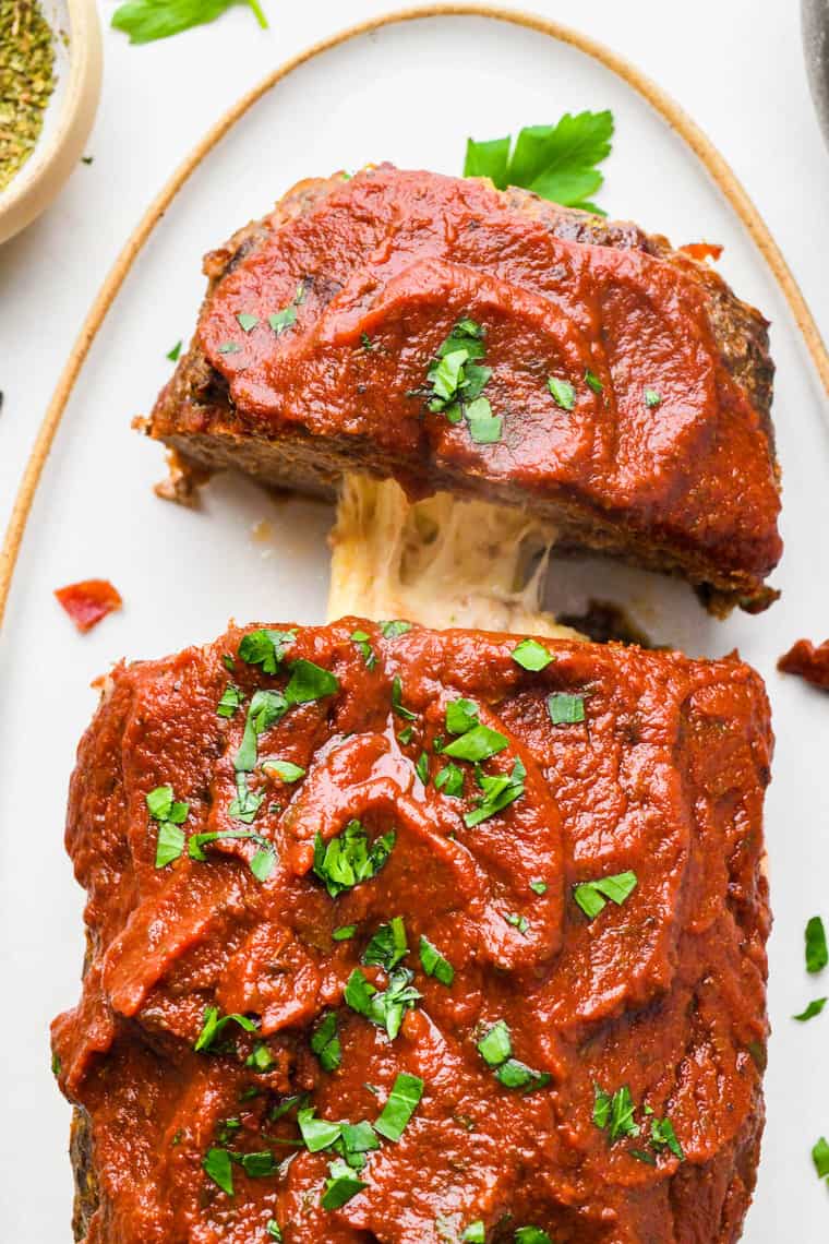 A pizza stuffed meatloaf with melted cheese pulling!