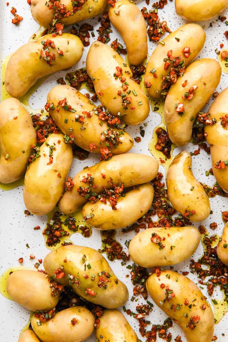 Fingerling potatoes tossed in seasoning mixture before baking