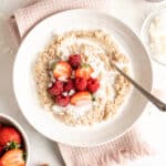 A close up of a homemade rice pudding with a spoon ready to enjoy