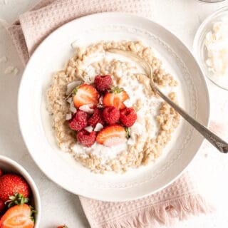 A close up of a homemade rice pudding with a spoon ready to enjoy