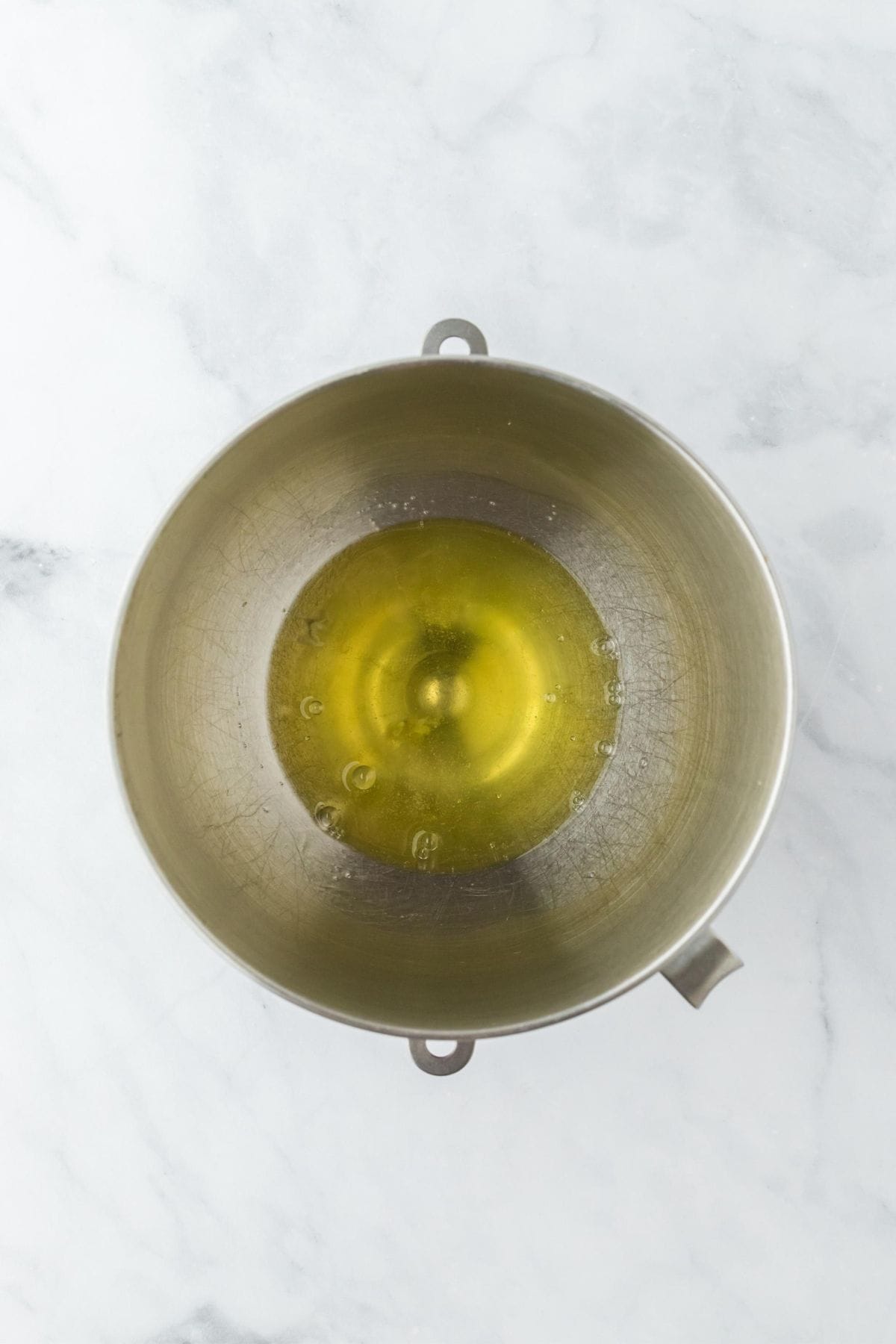 Egg whites in a metal mixing bowl, ready for whipping