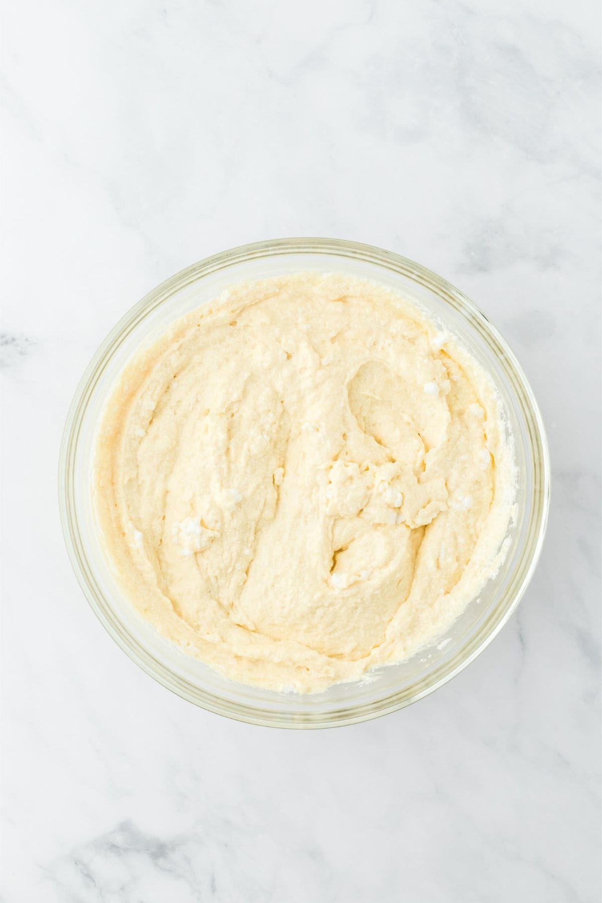 Smooth cake batter in a clear glass bowl