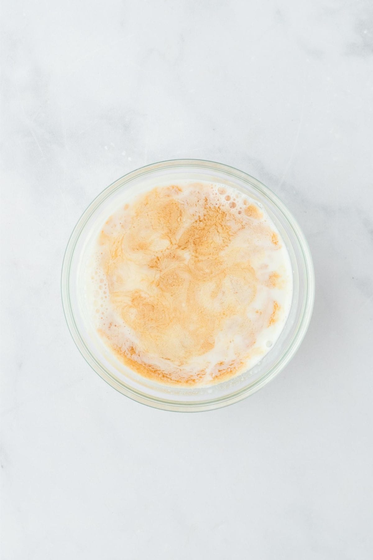 A glass bowl with wet ingredients mixed