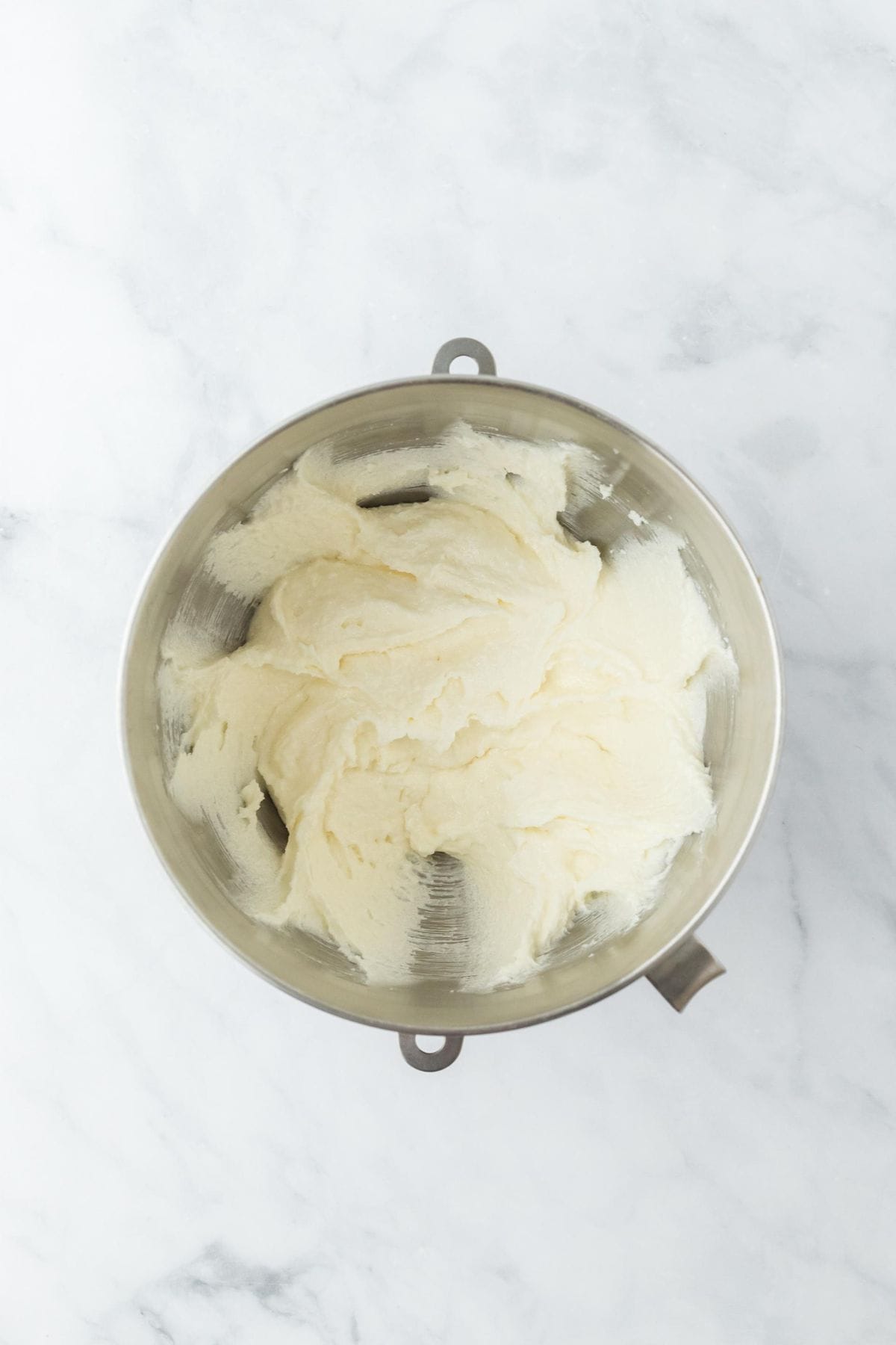 Creamed butter and sugar in a metal mixing bowl