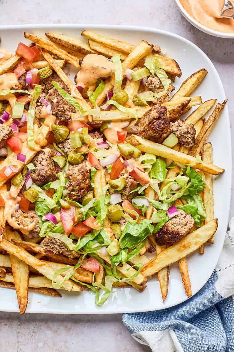Loaded fries on a white plate ready to serve