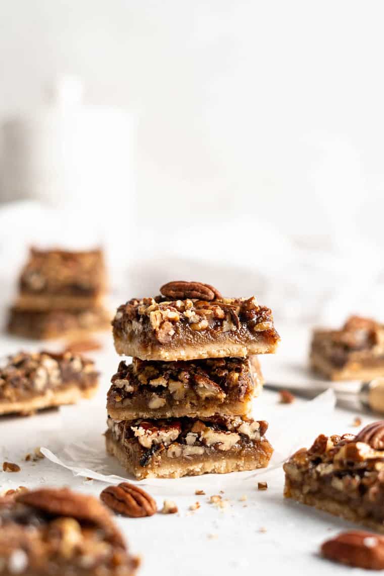 Stacks of pecan pie bar recipe against a white background