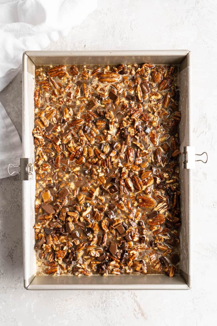 Freshly baked pecan bars in a long baking pan after coming out of the oven