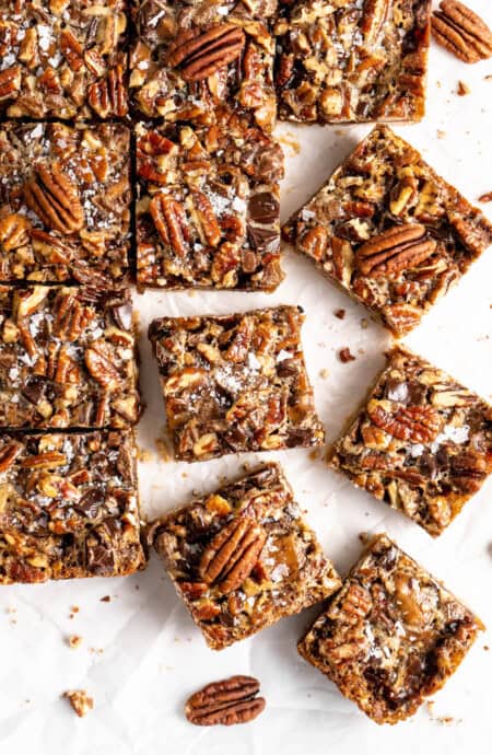 Cut pecan pie bars against a white background ready to serve