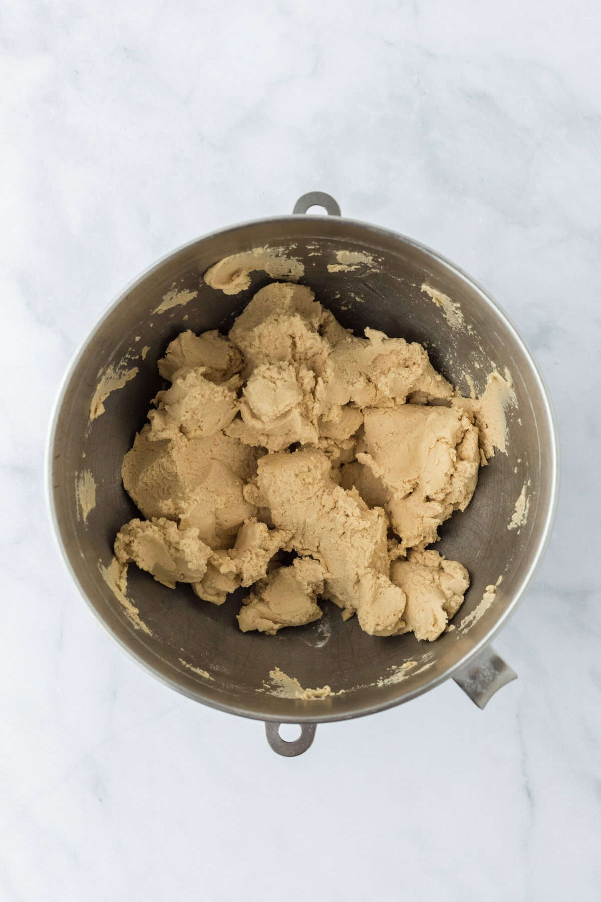 Shortbread cookie dough mixed together in a stand mixer bowl