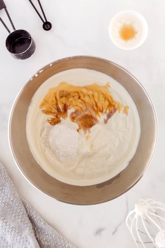 Heavy whipping cream whipped to soft peaks with sugar and vanilla added to a silver mixing bowl