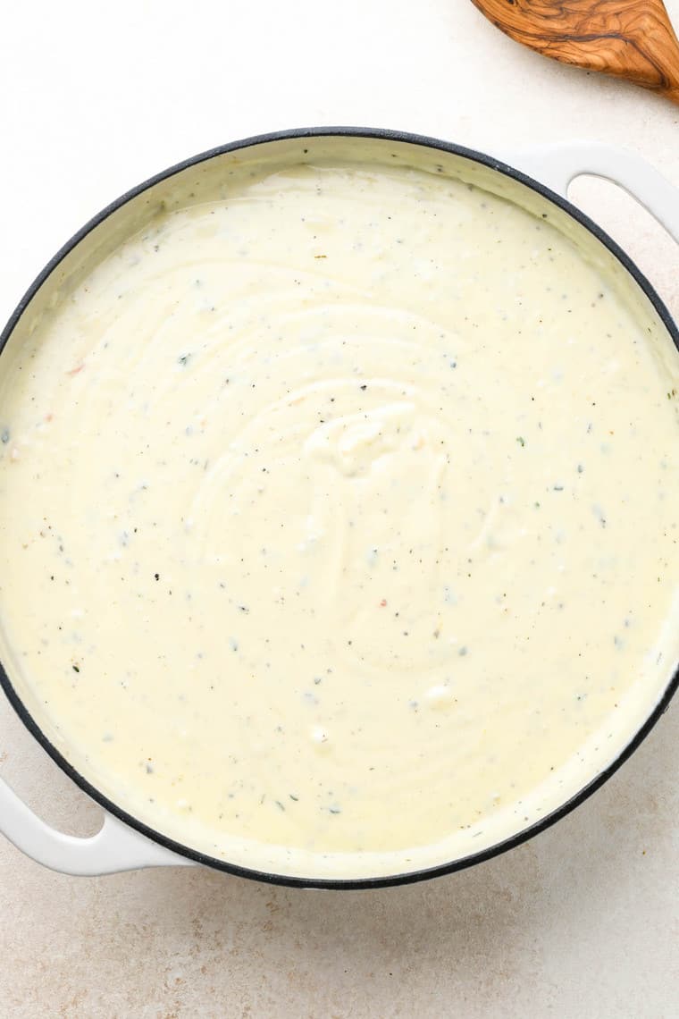 A creamy cheese sauce in a large pot