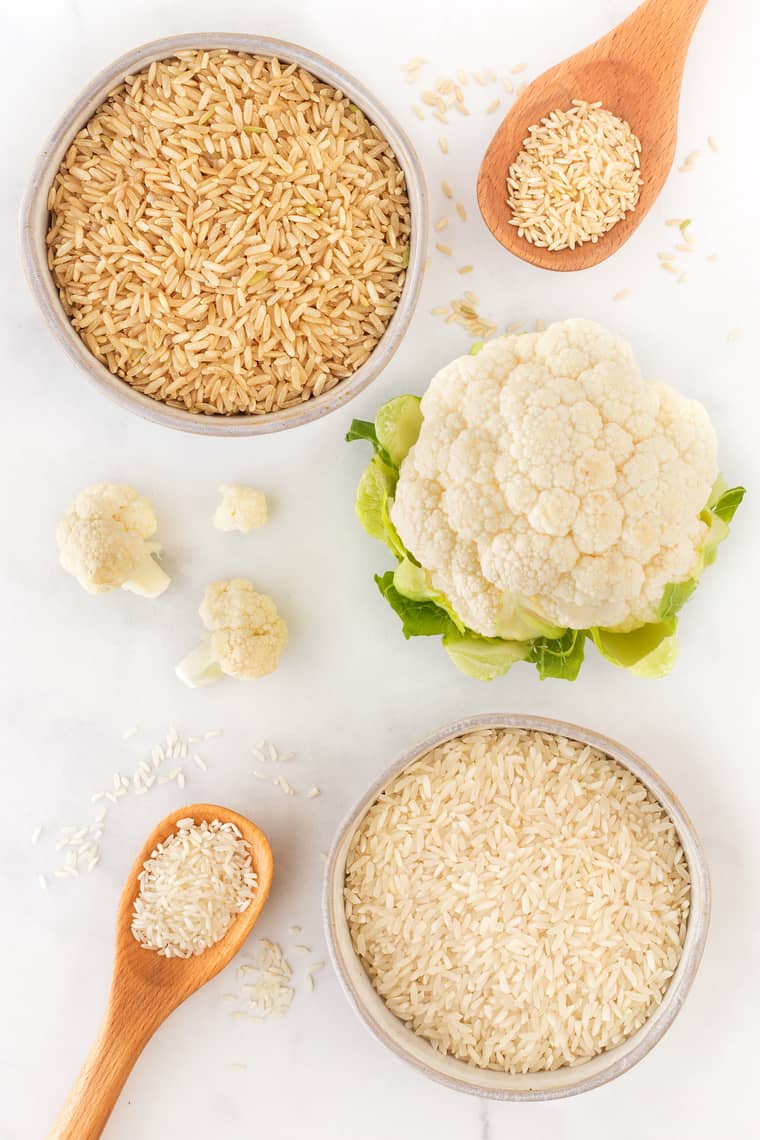 An overhead of brown rice, basmati, cauliflower and white rice in a tutorial on how to make rice