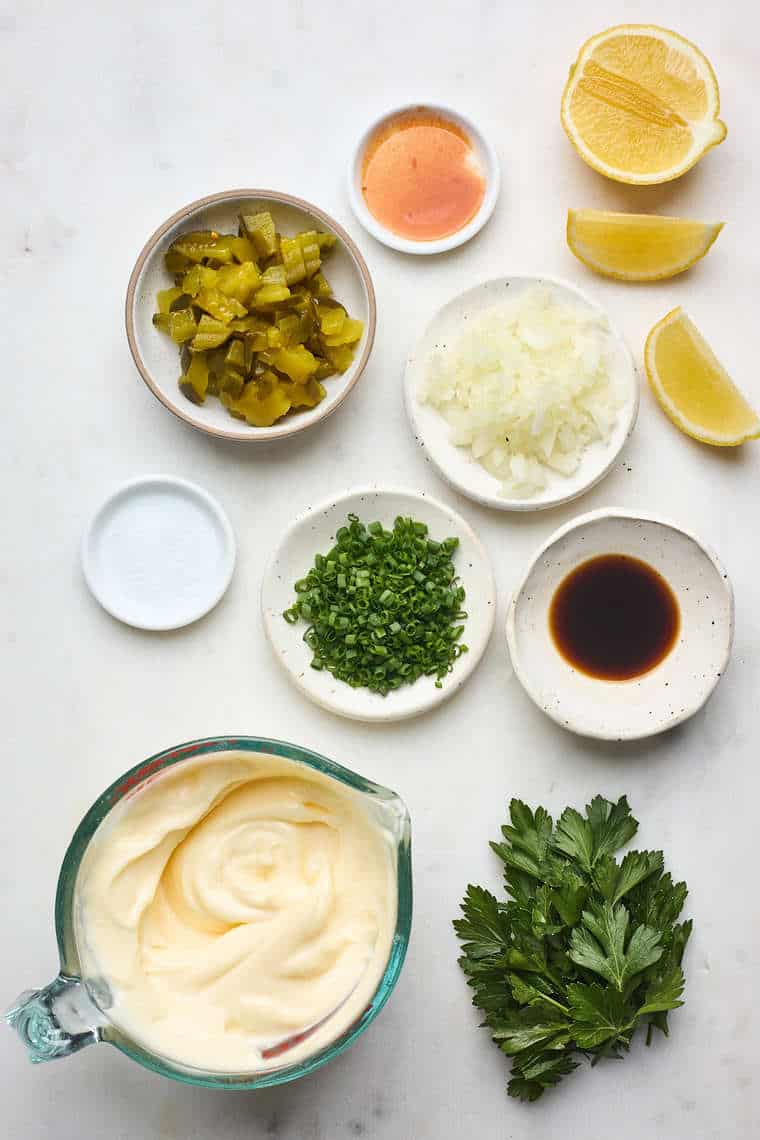 Mayo, pickles, chives, and other ingredients to mix together