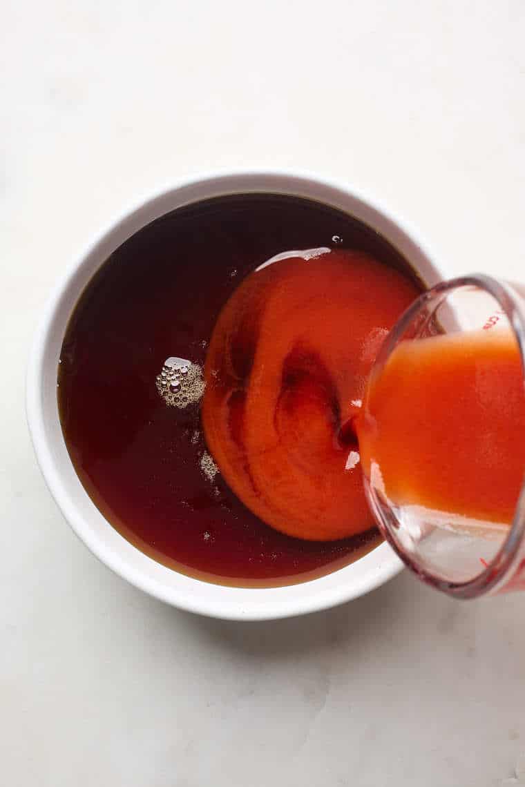 Hot sauce being poured into maple syrup