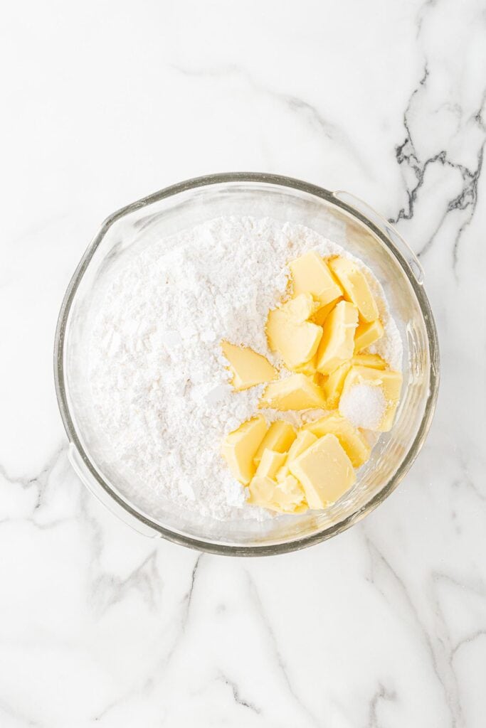 Butter and powdered sugar in stand mixer bowl