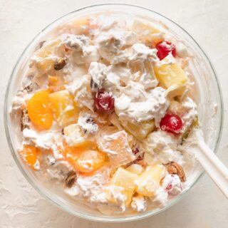 A close up of southern ambrosia salad in a clear bowl before serving