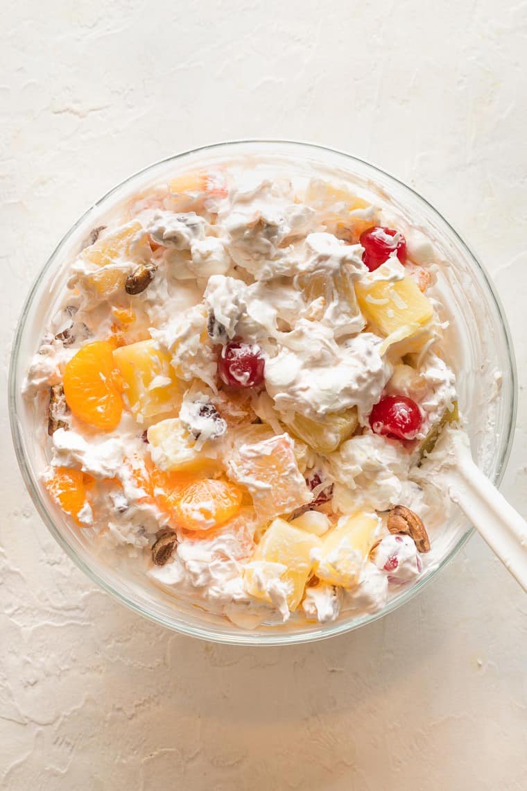 A close up of southern ambrosia salad in a clear bowl before serving