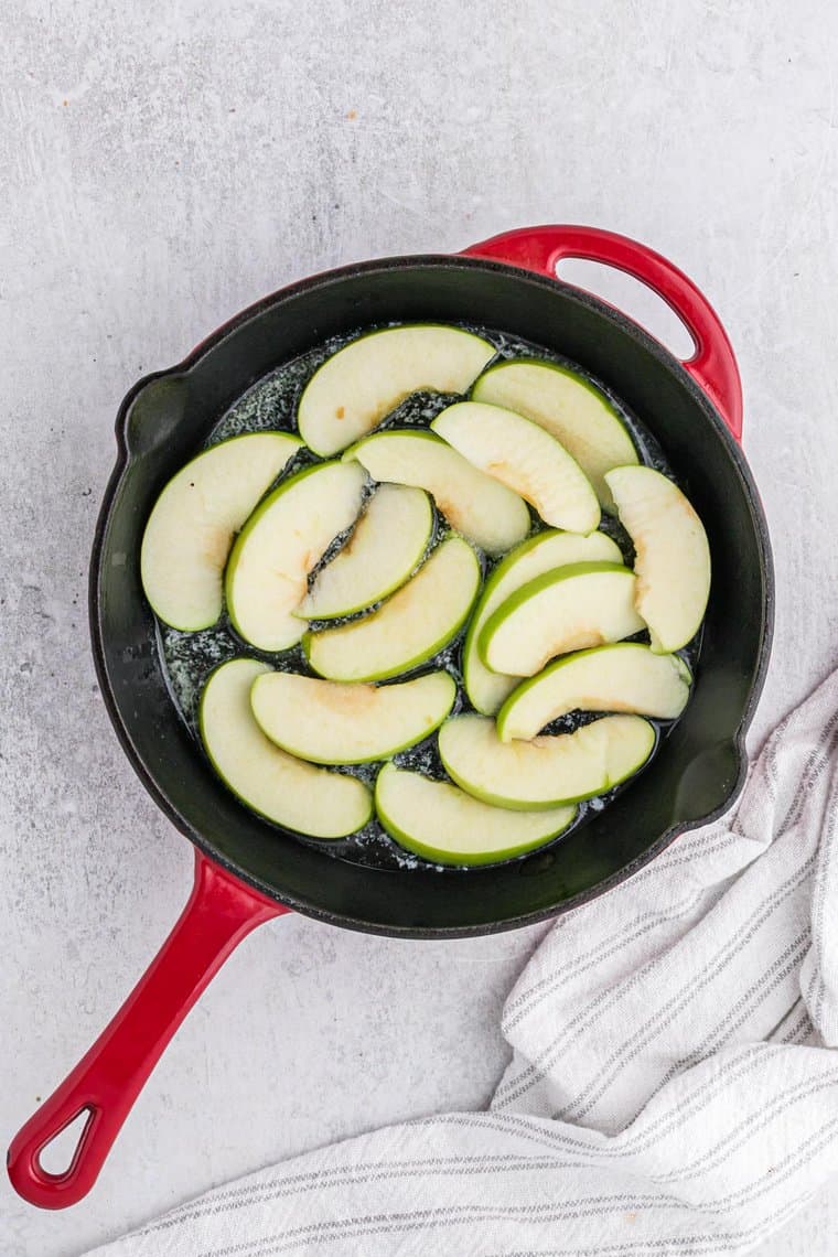 Sliced apples in a skillet in an even layer