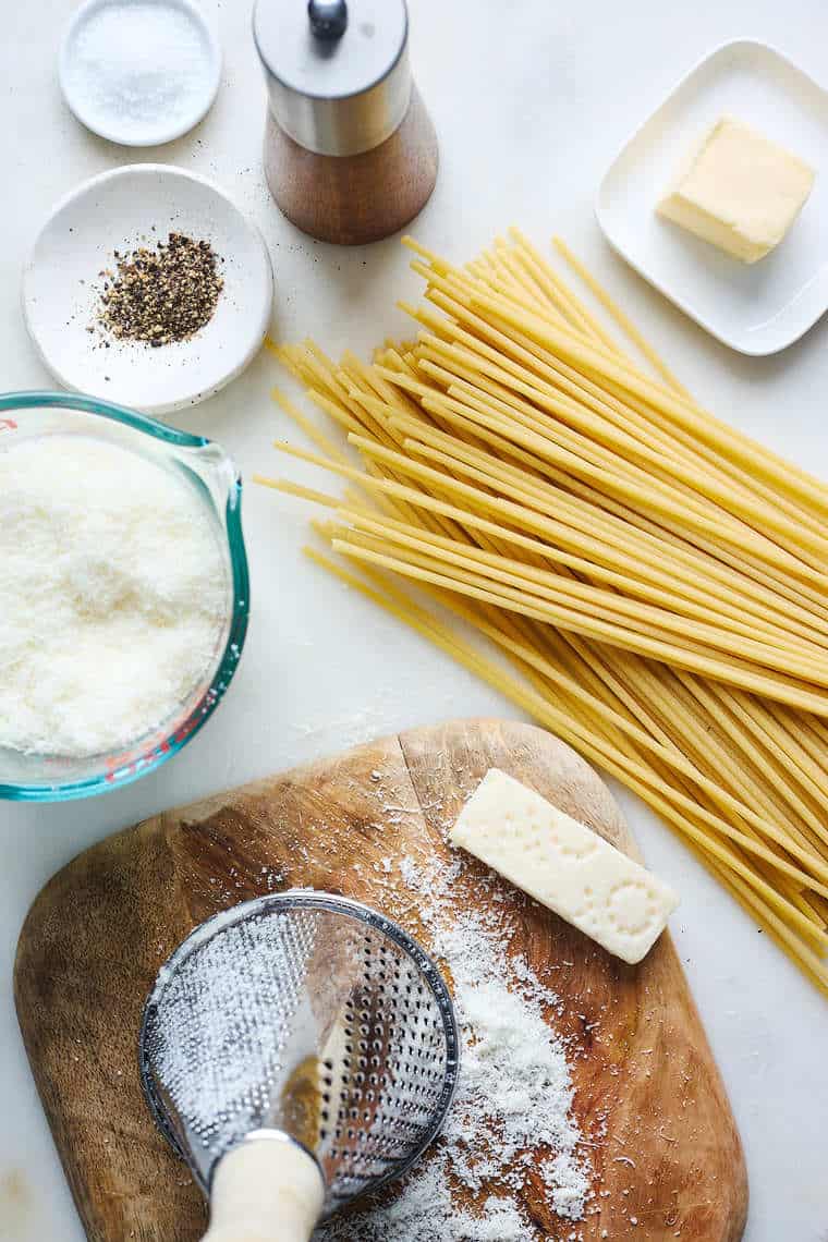 Ingredients for pasta with pepper, cheese and butter nearby