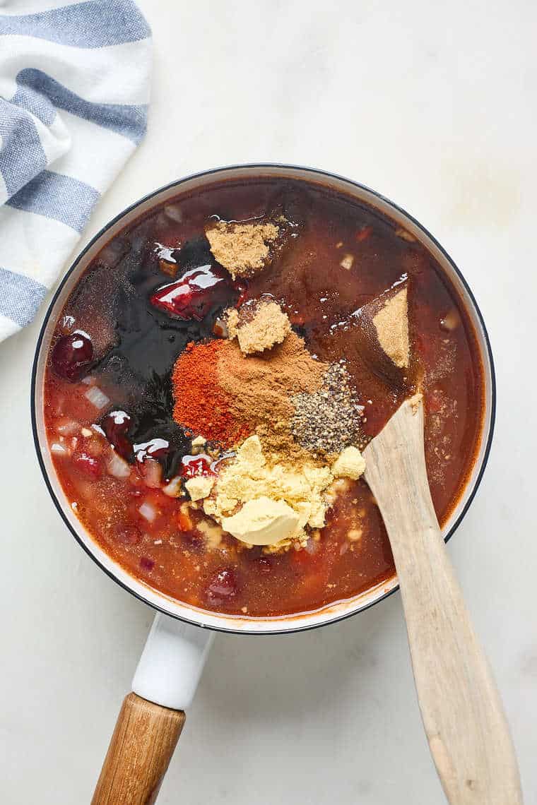 Chipotle bbq sauce ingredients being stirred together in a large pot