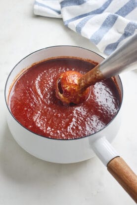 Cherry bbq sauce being blended together with an immersion blender