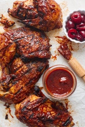 A delicious cherry chipotle bbq sauce next to barbecue chicken after adding to it