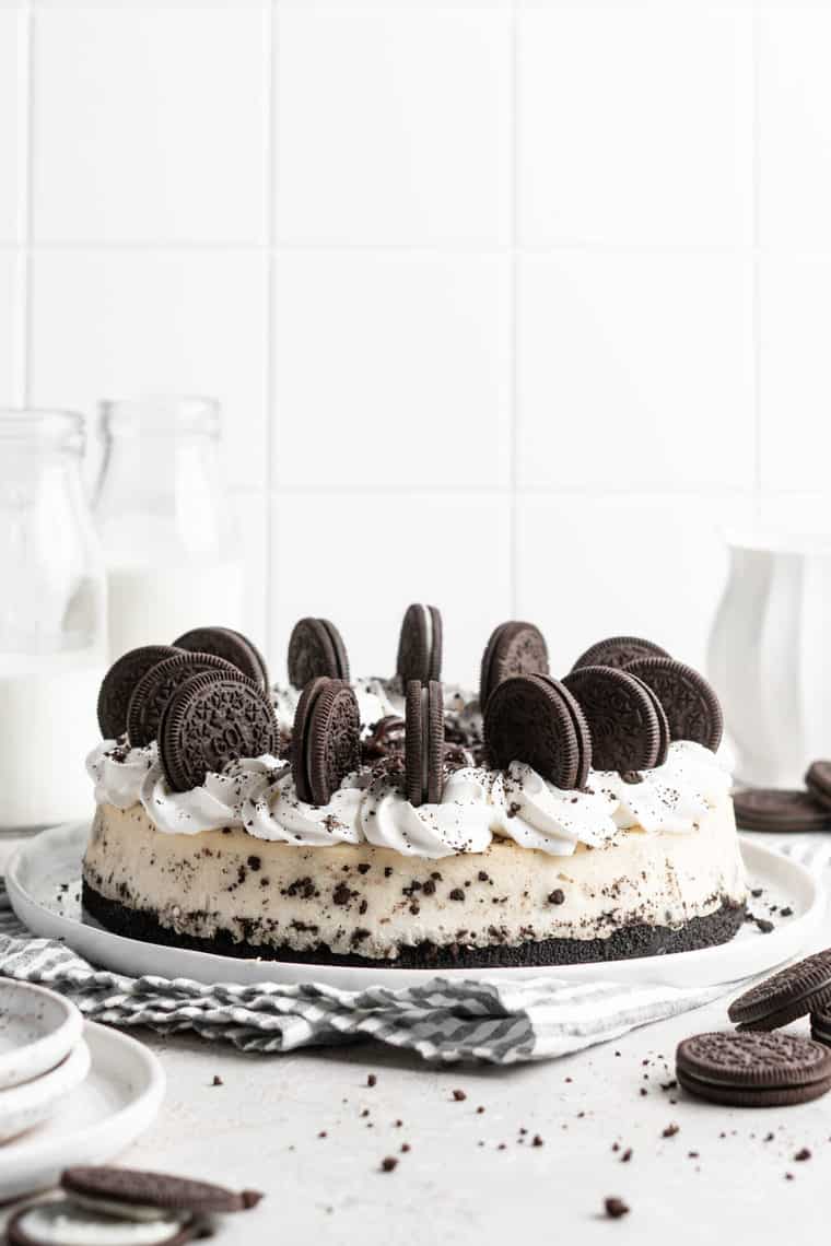 A delicious cookies and cream cheesecake against a white background ready to serve